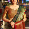 Beauteous Dark Green Patola Silk Saree with Pleasant Blouse Piece