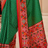 Denouement Dark Green Patola Silk Saree with Moiety Blouse Piece